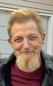 Man smiling outside near building