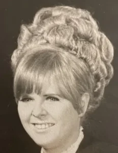 Vintage photo of person with elaborate hairstyle.