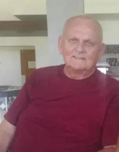 Elderly man sitting in a living room.